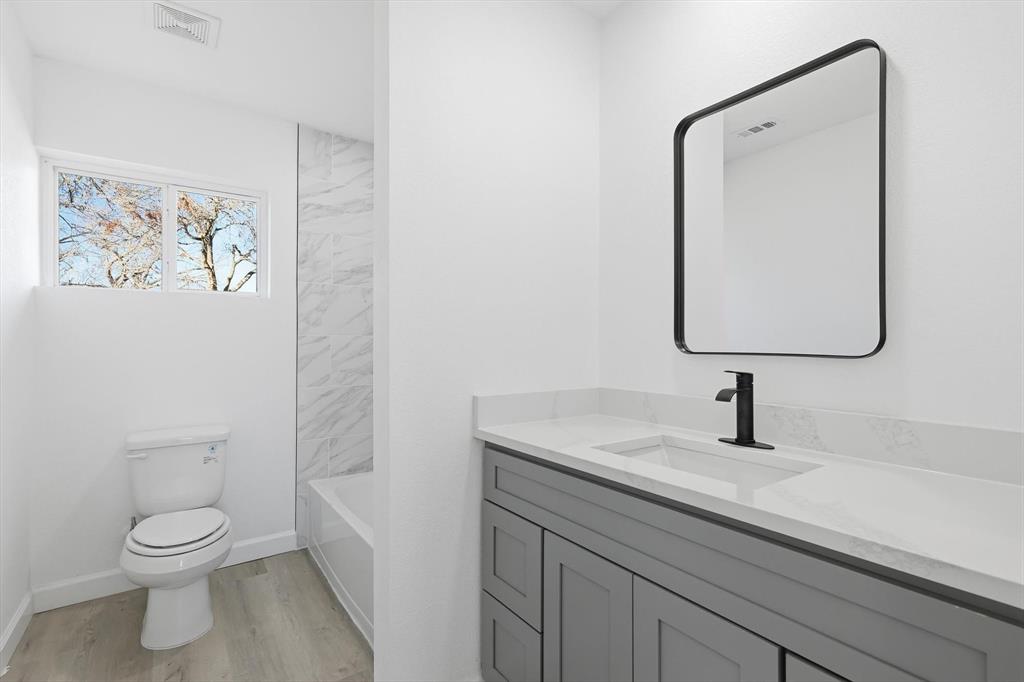 2900 Old Orchard Road Garland, TX 75041 - Photo 13 of 18 a bathroom with a toilet sink and mirror