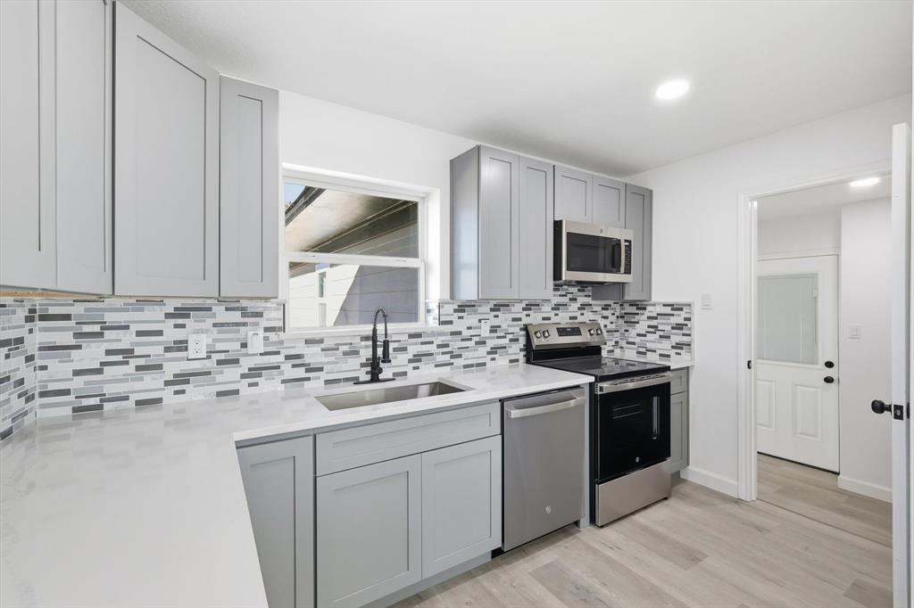 2900 Old Orchard Road Garland, TX 75041 - Photo 3 of 18 a kitchen with a sink stove and microwave