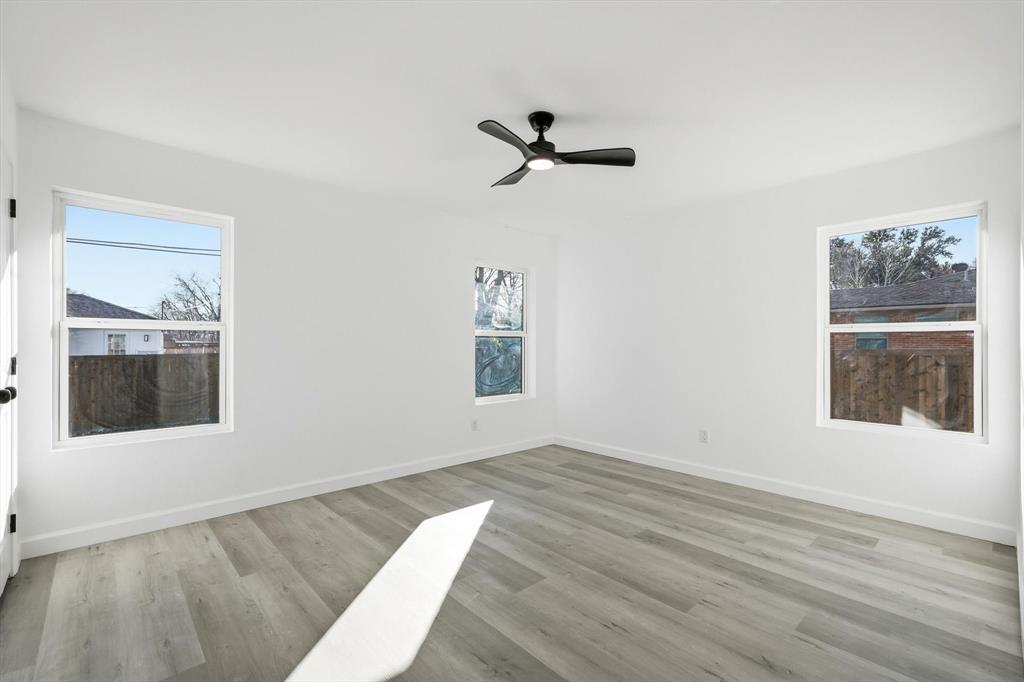 2900 Old Orchard Road Garland, TX 75041 - Photo 9 of 18 a view of a big room with wooden floor and windows