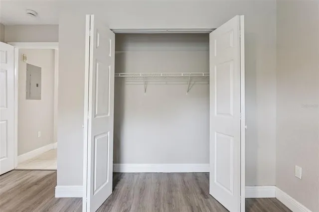 a view of an empty room with wooden floor