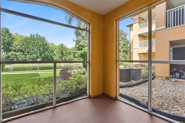 a large building with a big yard plants and big trees