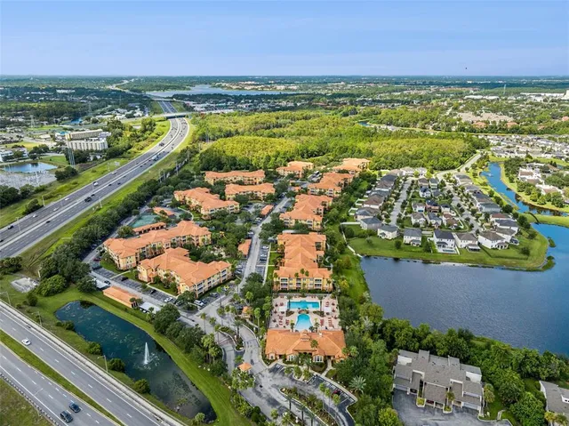 an aerial view of a house with outdoor space and a lake view