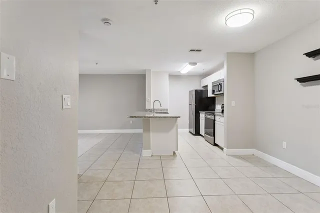 a view of kitchen with refrigerator cabinets and outdoor space