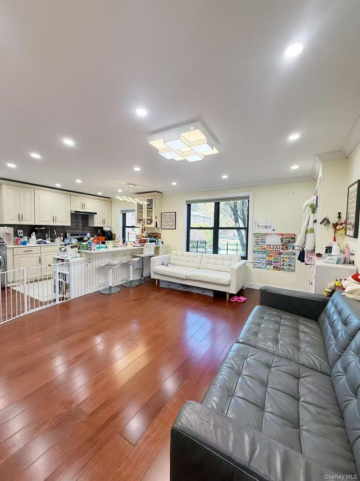 196-36 67th Avenue, Unit 1 Queens, NY 11365 - Photo 4 of 10 a living room with lots of furniture and kitchen view