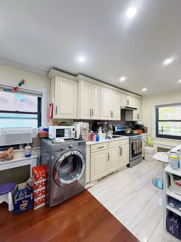a kitchen with sink a stove and cabinets