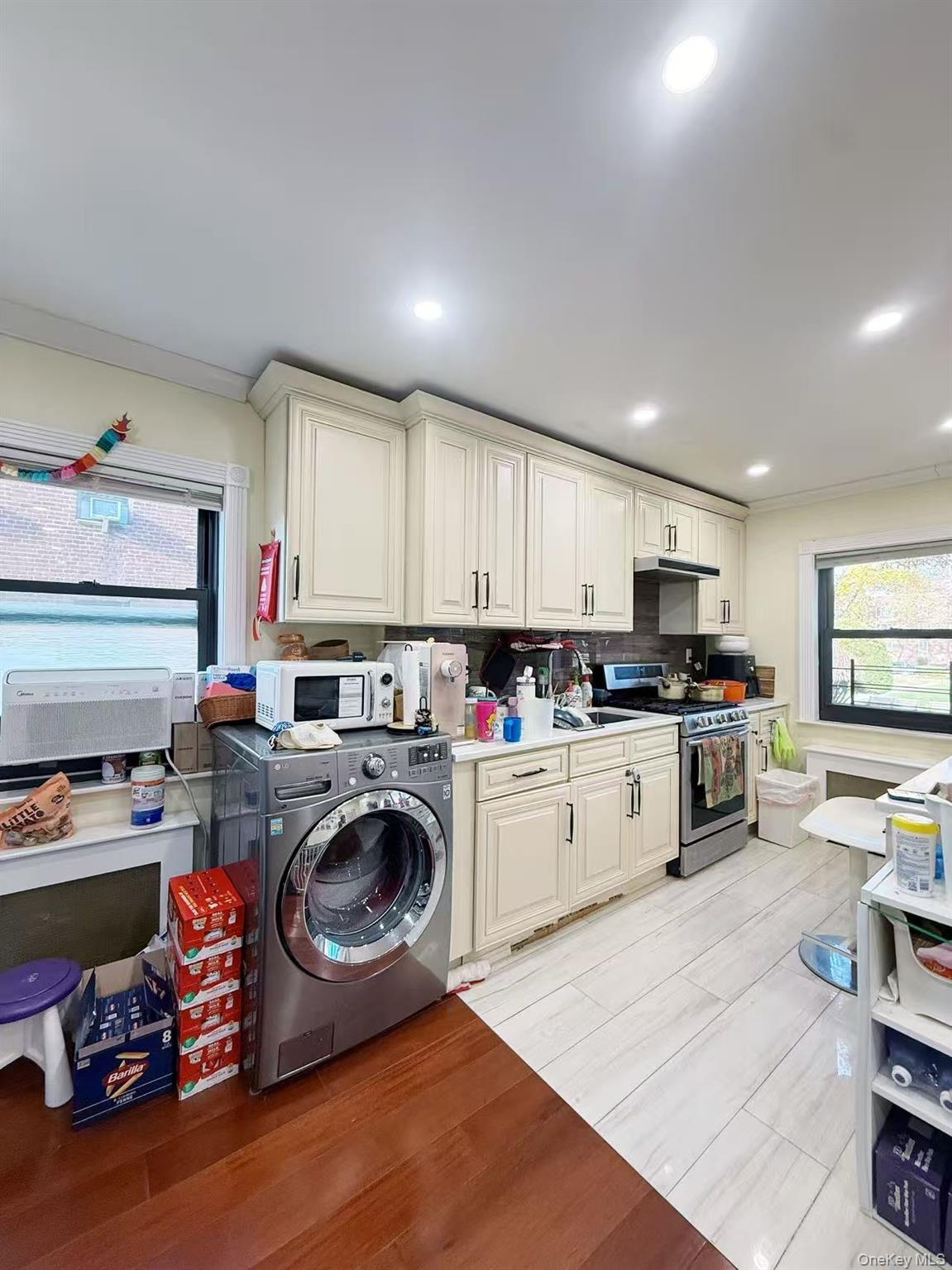 196-36 67th Avenue, Unit 1 Queens, NY 11365 - Photo 5 of 10 a kitchen with sink a stove and cabinets