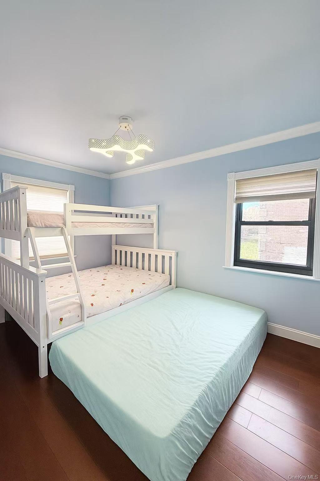 196-36 67th Avenue, Unit 1 Queens, NY 11365 - Photo 6 of 10 a bedroom with a bed and window