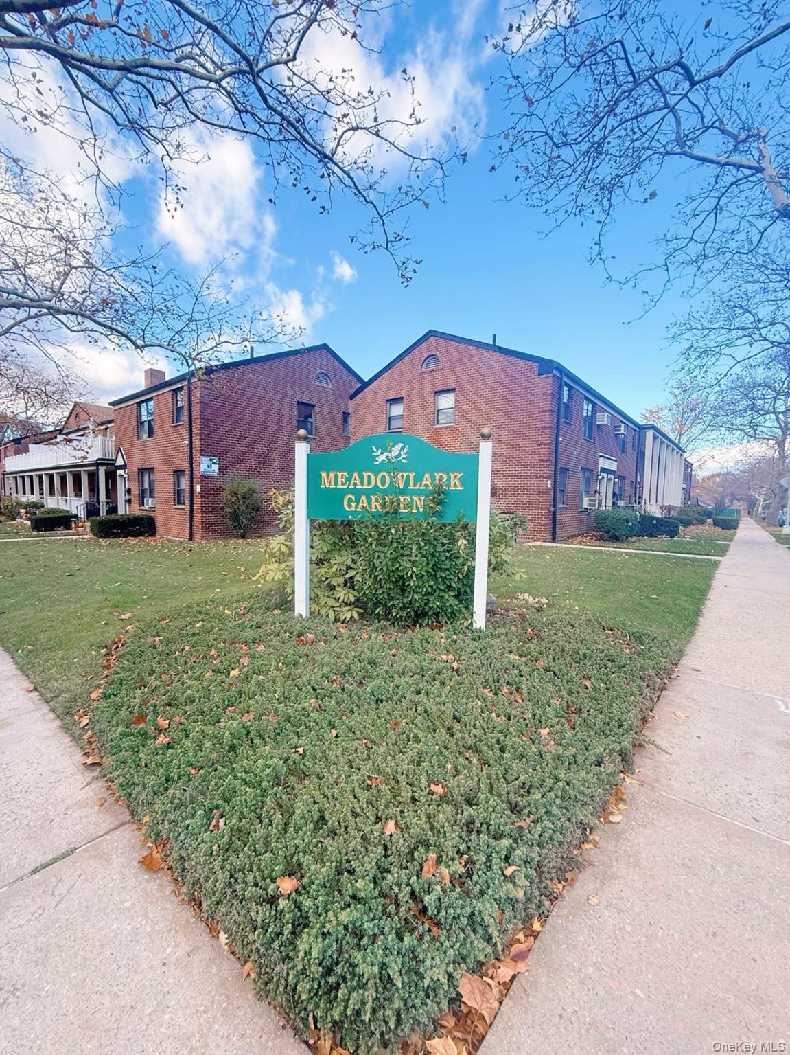 196-36 67th Avenue, Unit 1 Queens, NY 11365 - Photo 9 of 10 front view of a house with a yard