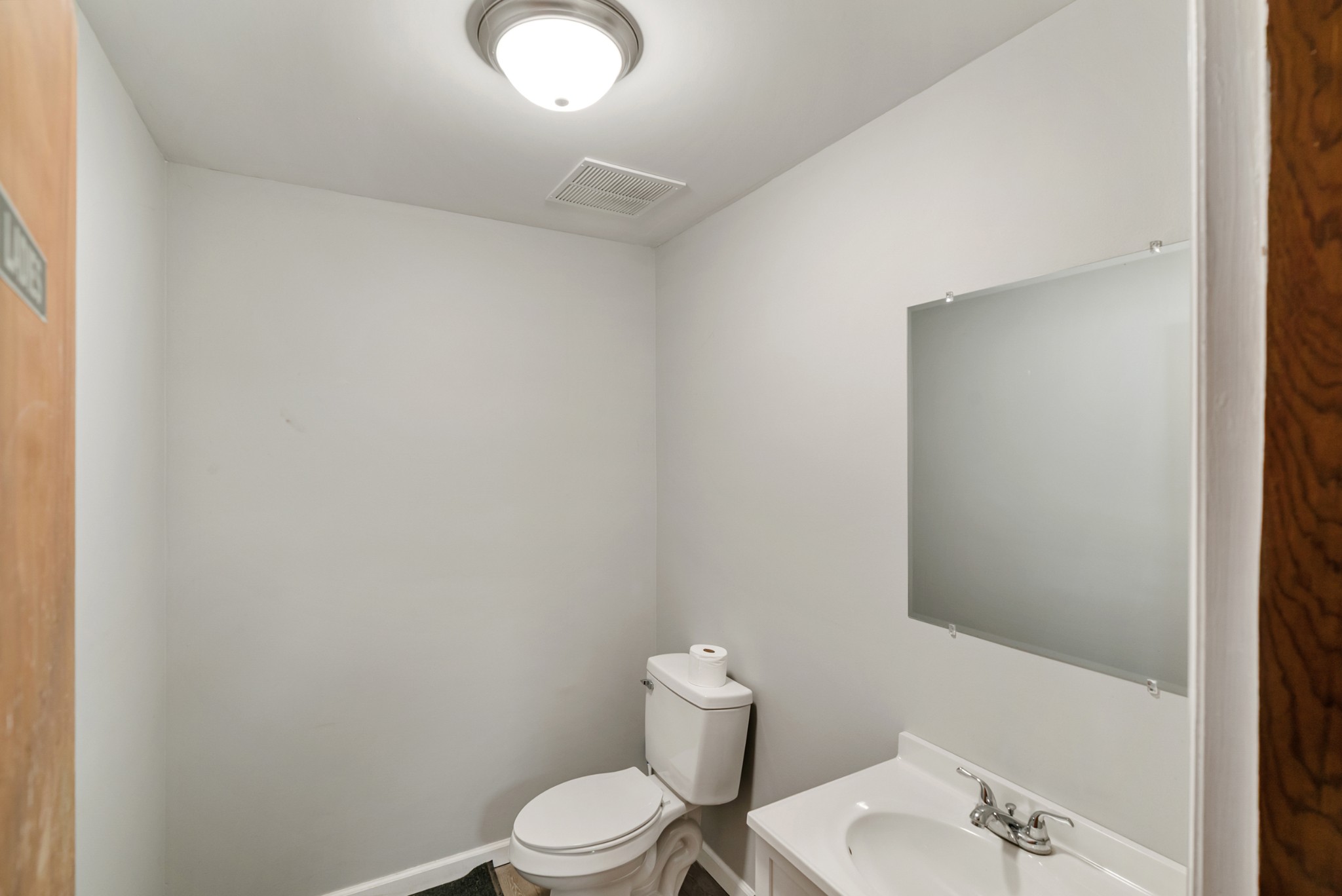 4000 Memorial Boulevard Springfield, TN 37172 - Photo 32 of 40 a white toilet sitting next to a bathroom sink and vanity