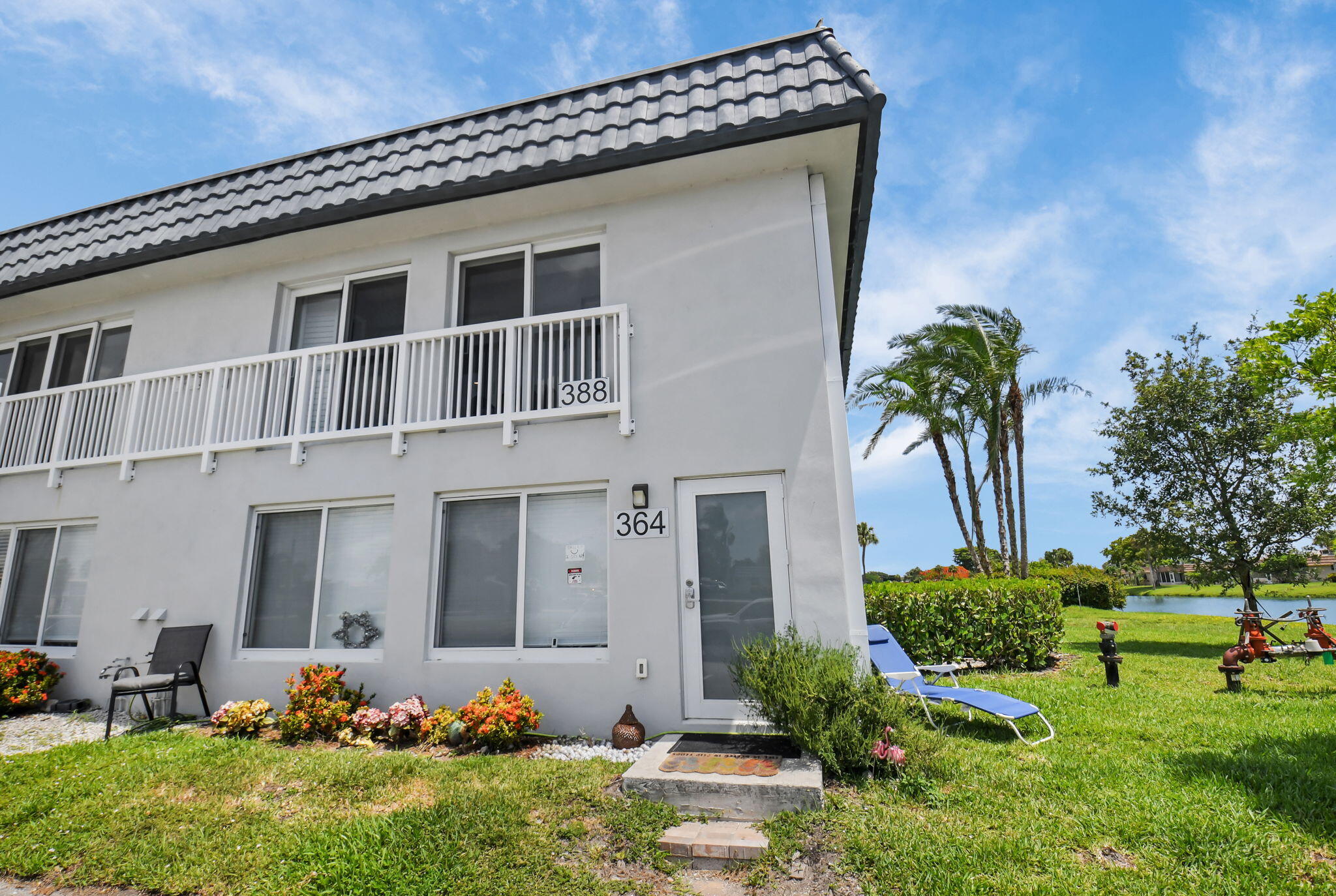 388 Tuscany Lane, Unit 388 Delray Beach, FL 33446 - Photo 1 of 89 a front view of a house with a yard
