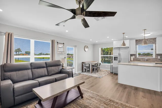a kitchen with cabinets stainless steel appliances a sink and a stove