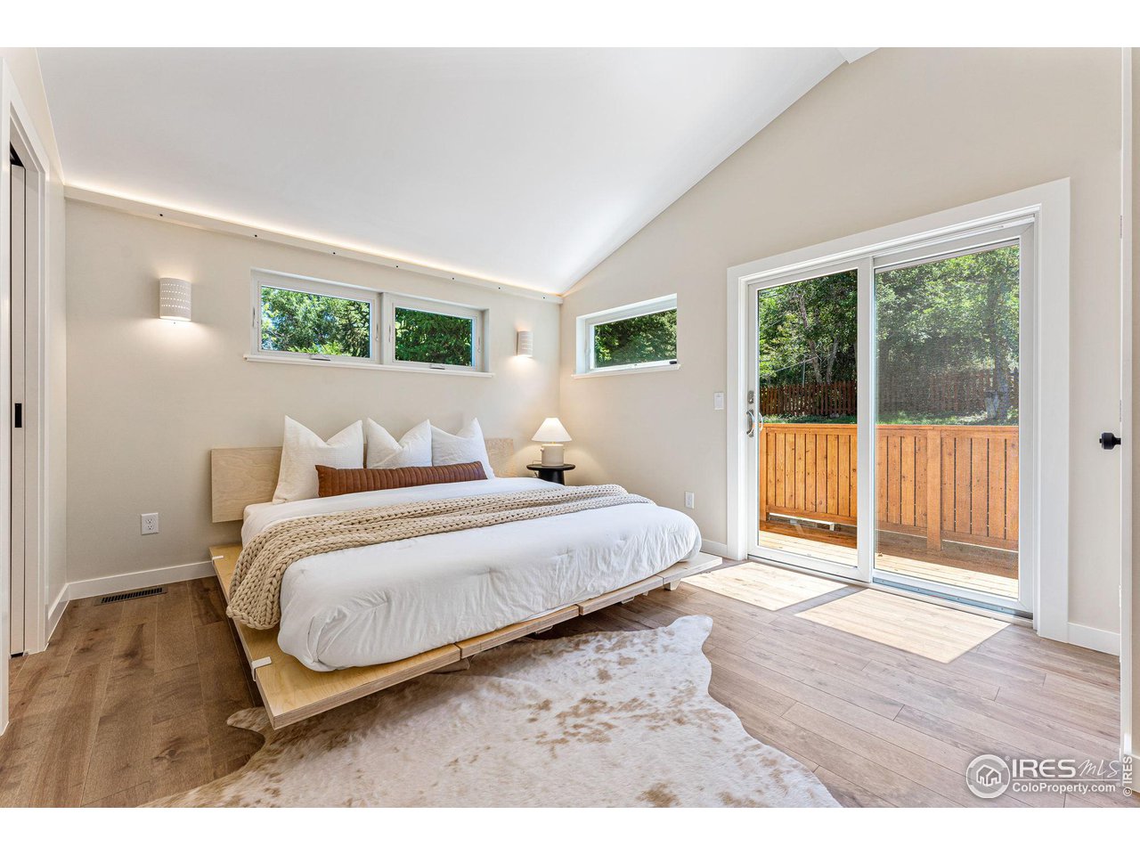 1616 North Street Boulder, CO 80304 - Photo 11 of 32 a bedroom with a bed and wooden floor