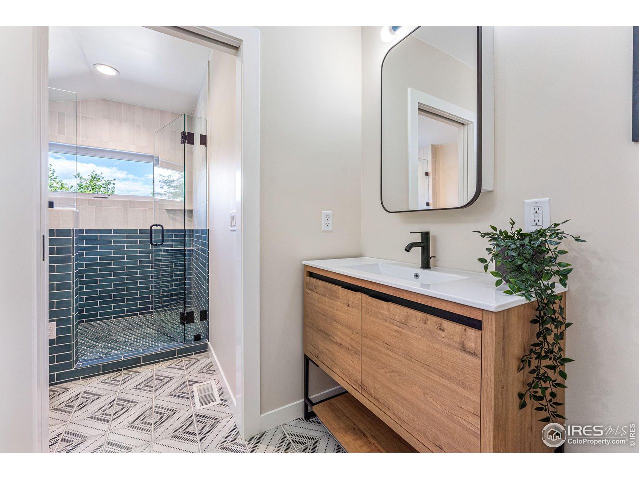 1616 North Street Boulder, CO 80304 - Photo 12 of 32 a bathroom with a sink a mirror and shower