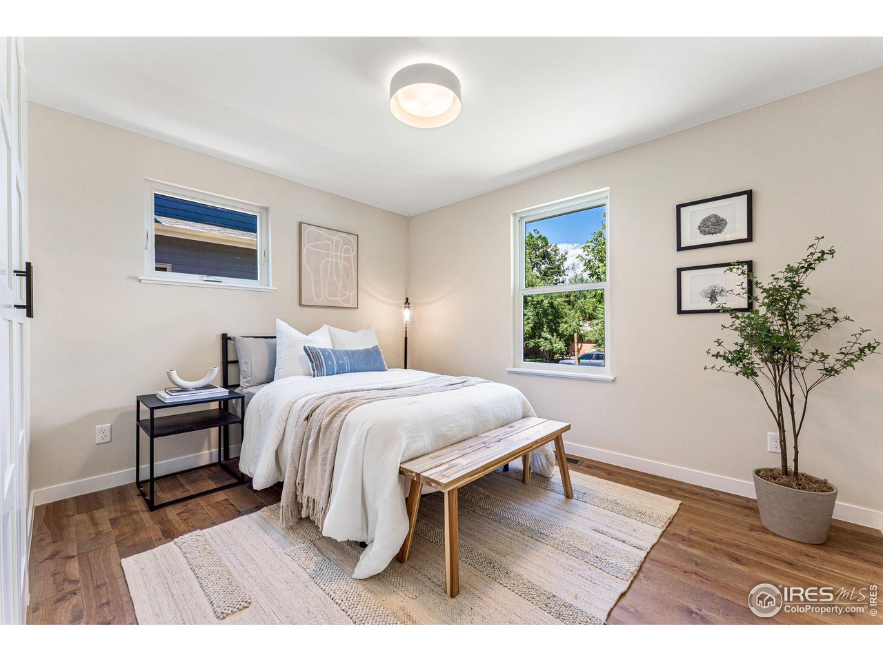 1616 North Street Boulder, CO 80304 - Photo 15 of 32 a bedroom with a bed and a potted plant