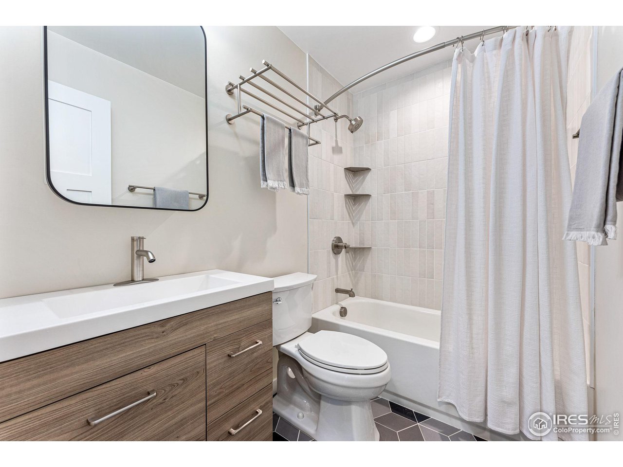 1616 North Street Boulder, CO 80304 - Photo 19 of 32 a bathroom with a toilet a sink and a mirror