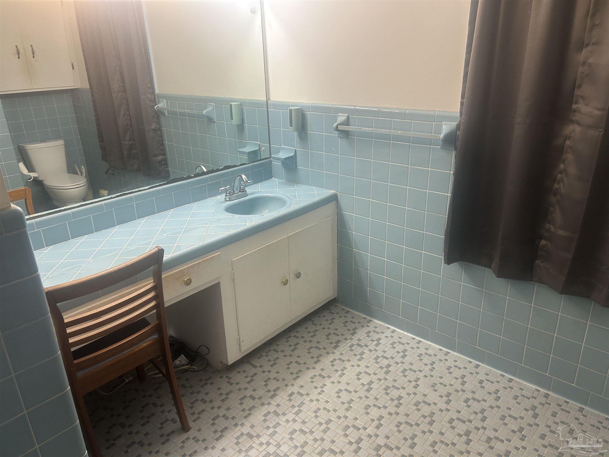 887 Old Bratt Road Atmore, AL 36502 - Photo 14 of 41 a bathroom with a sink a toilet and a mirror
