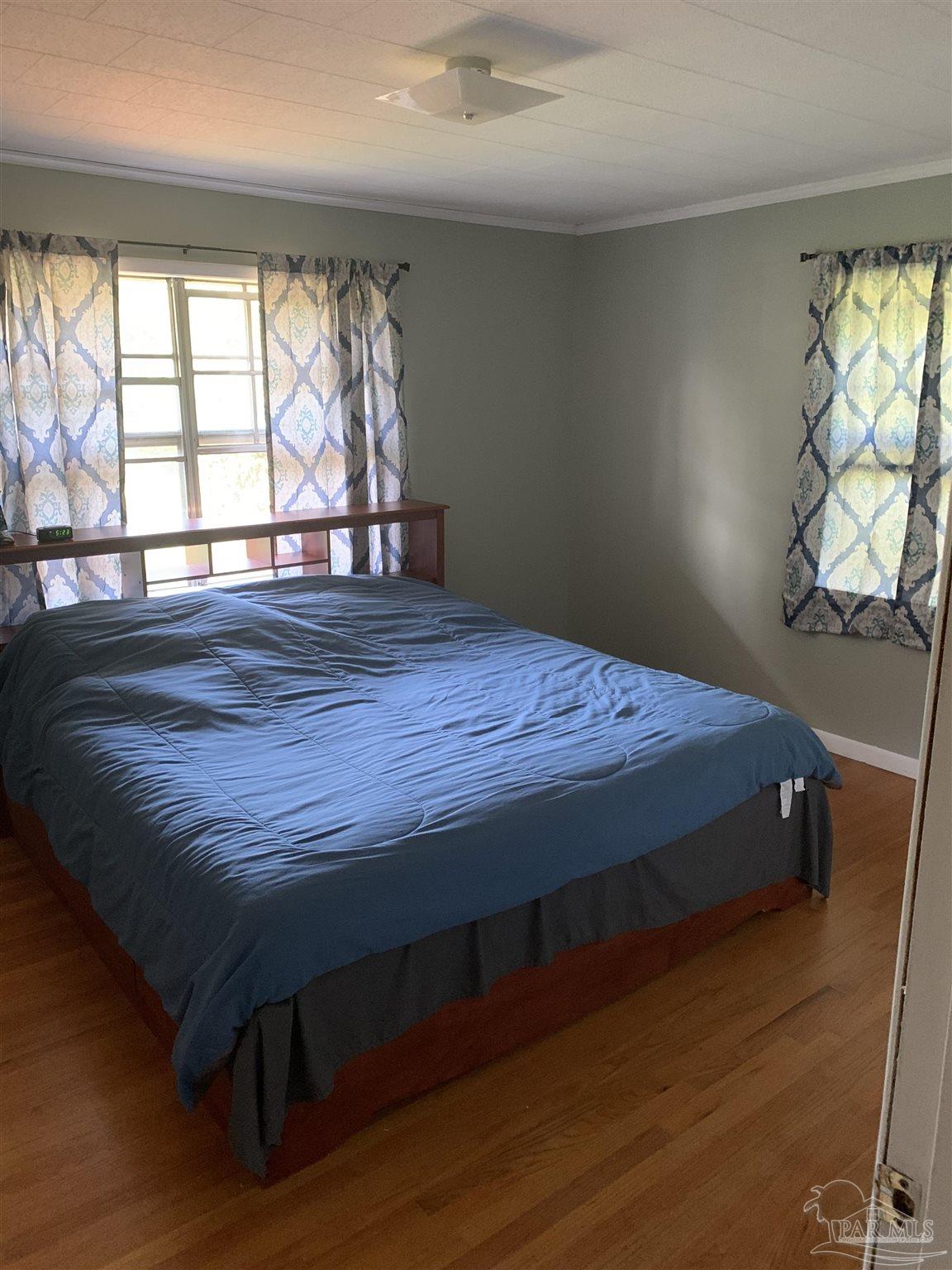 887 Old Bratt Road Atmore, AL 36502 - Photo 16 of 41 a bed sitting in a bedroom next to a window