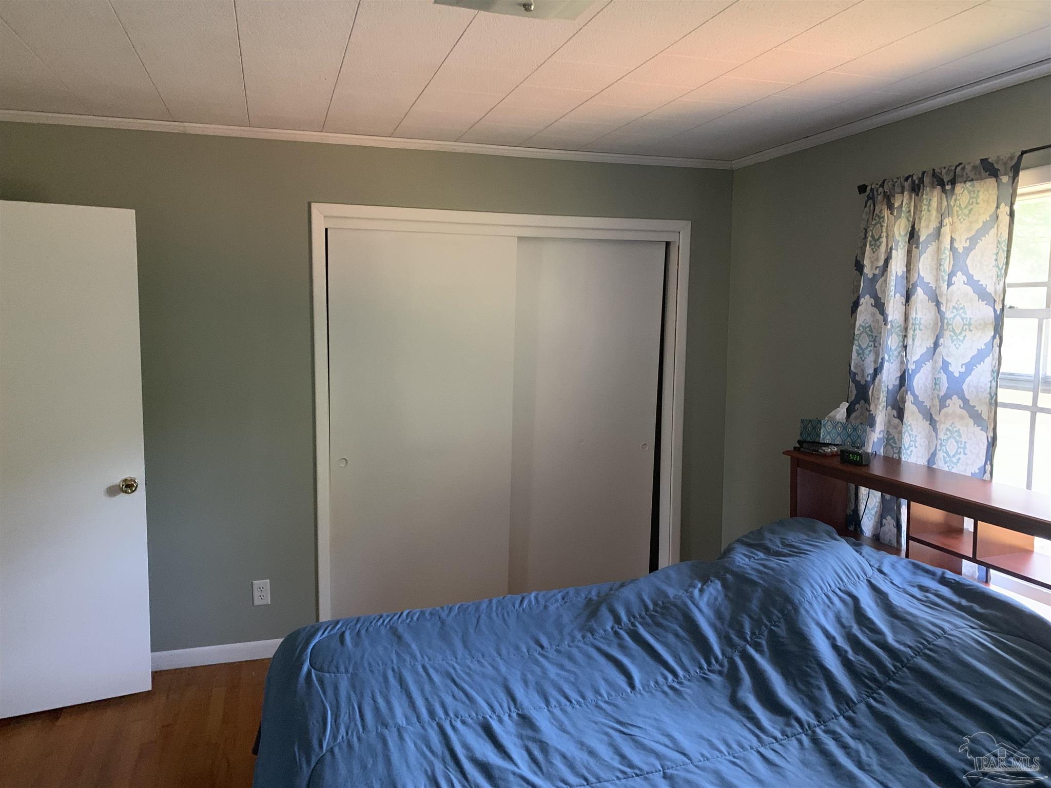 887 Old Bratt Road Atmore, AL 36502 - Photo 17 of 41 a view of an empty room with wooden floor and a window