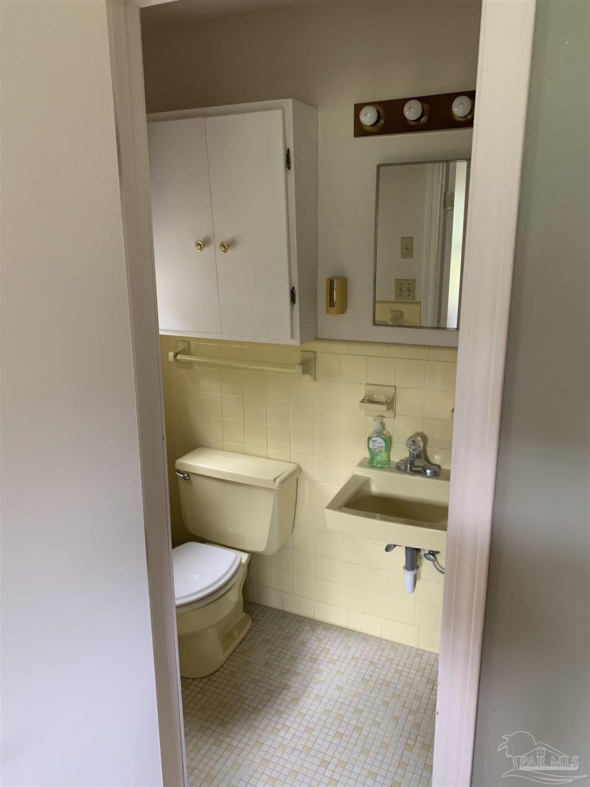 887 Old Bratt Road Atmore, AL 36502 - Photo 19 of 41 a bathroom with a toilet and a mirror