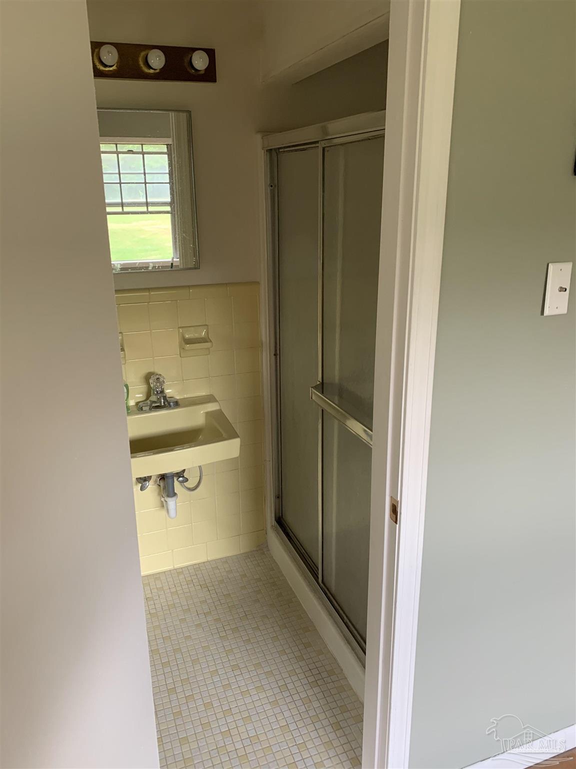 887 Old Bratt Road Atmore, AL 36502 - Photo 20 of 41 a bathroom with a sink and a window