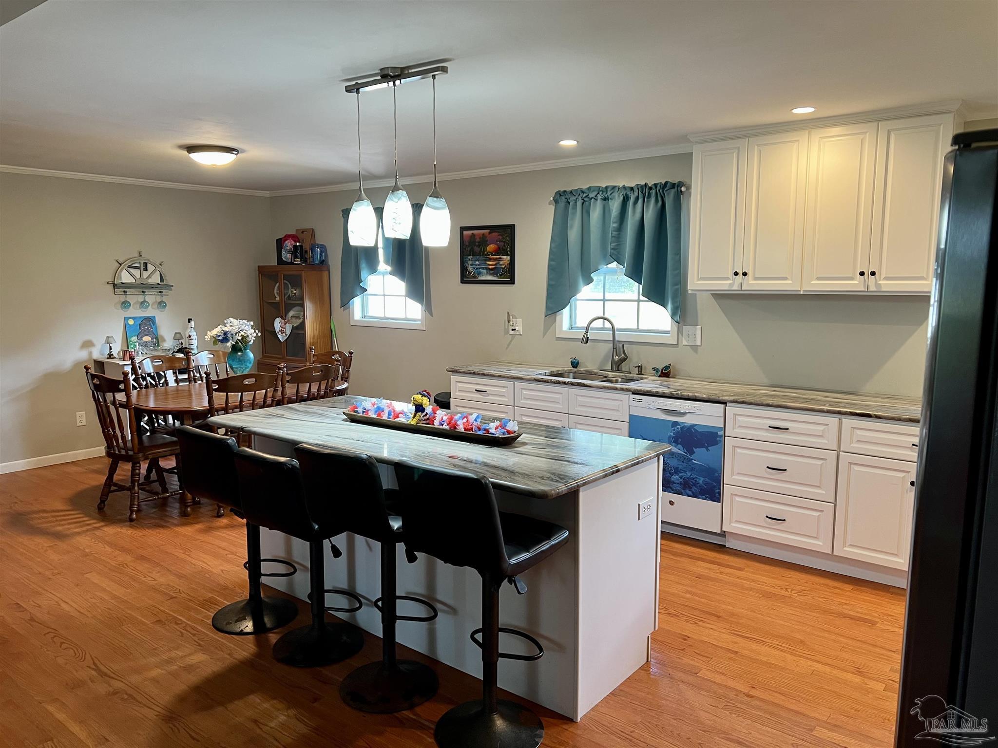 887 Old Bratt Road Atmore, AL 36502 - Photo 2 of 41 a kitchen with granite countertop a table chairs sink and cabinets
