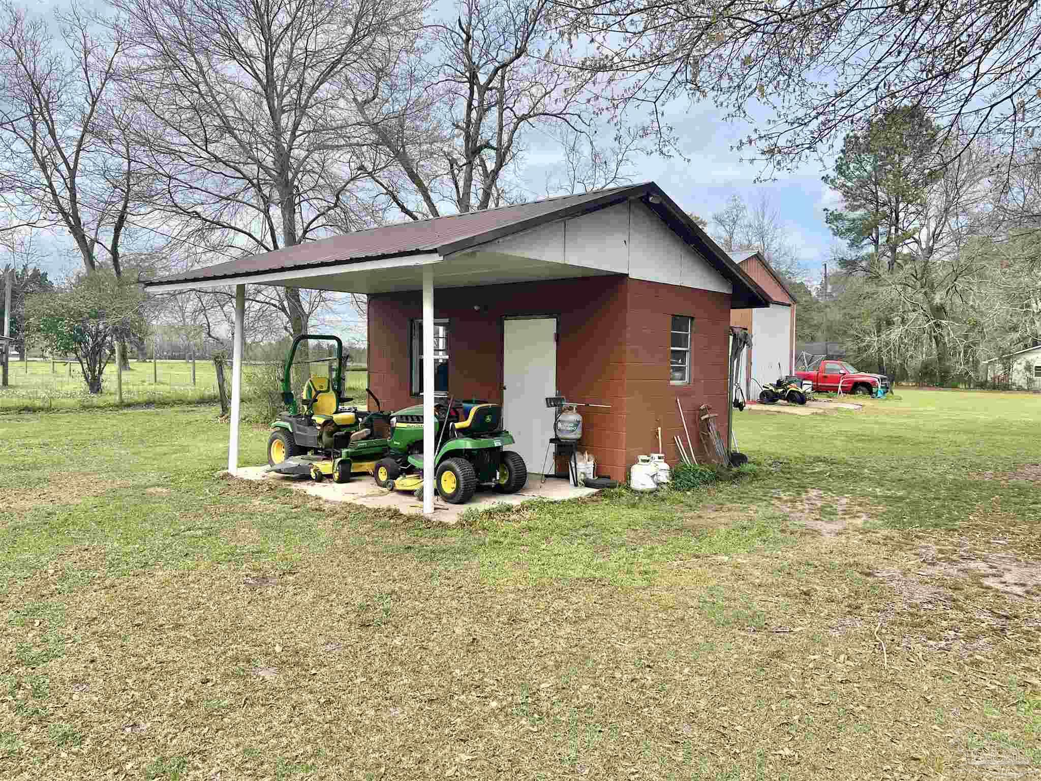 887 Old Bratt Road Atmore, AL 36502 - Photo 22 of 41 a view of a house with yard and plants