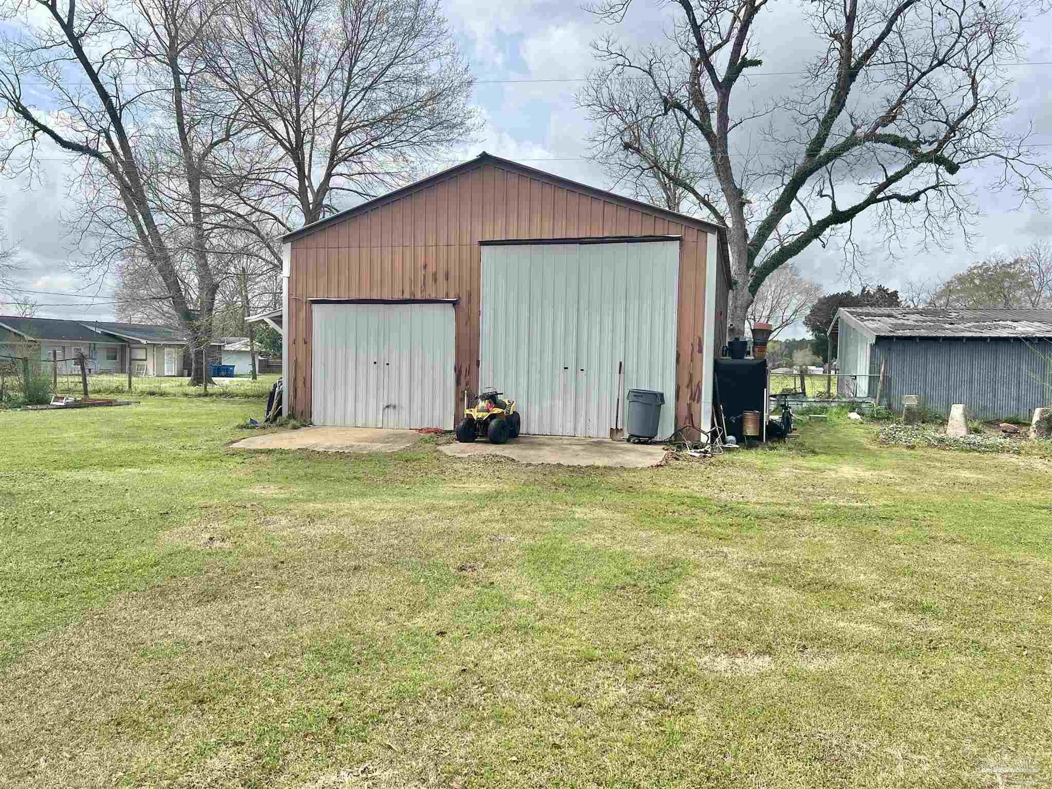 887 Old Bratt Road Atmore, AL 36502 - Photo 23 of 41 a view of a house with a yard and tree