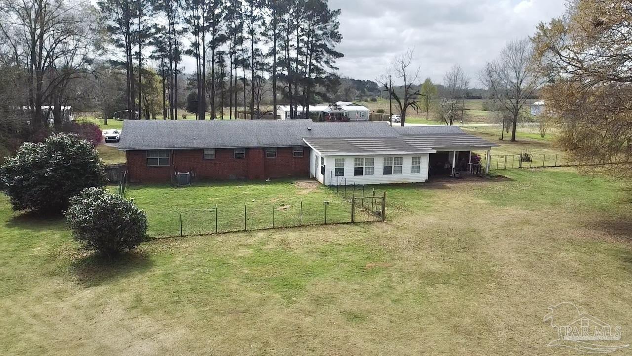 887 Old Bratt Road Atmore, AL 36502 - Photo 24 of 41 a view of a house with backyard and sitting area