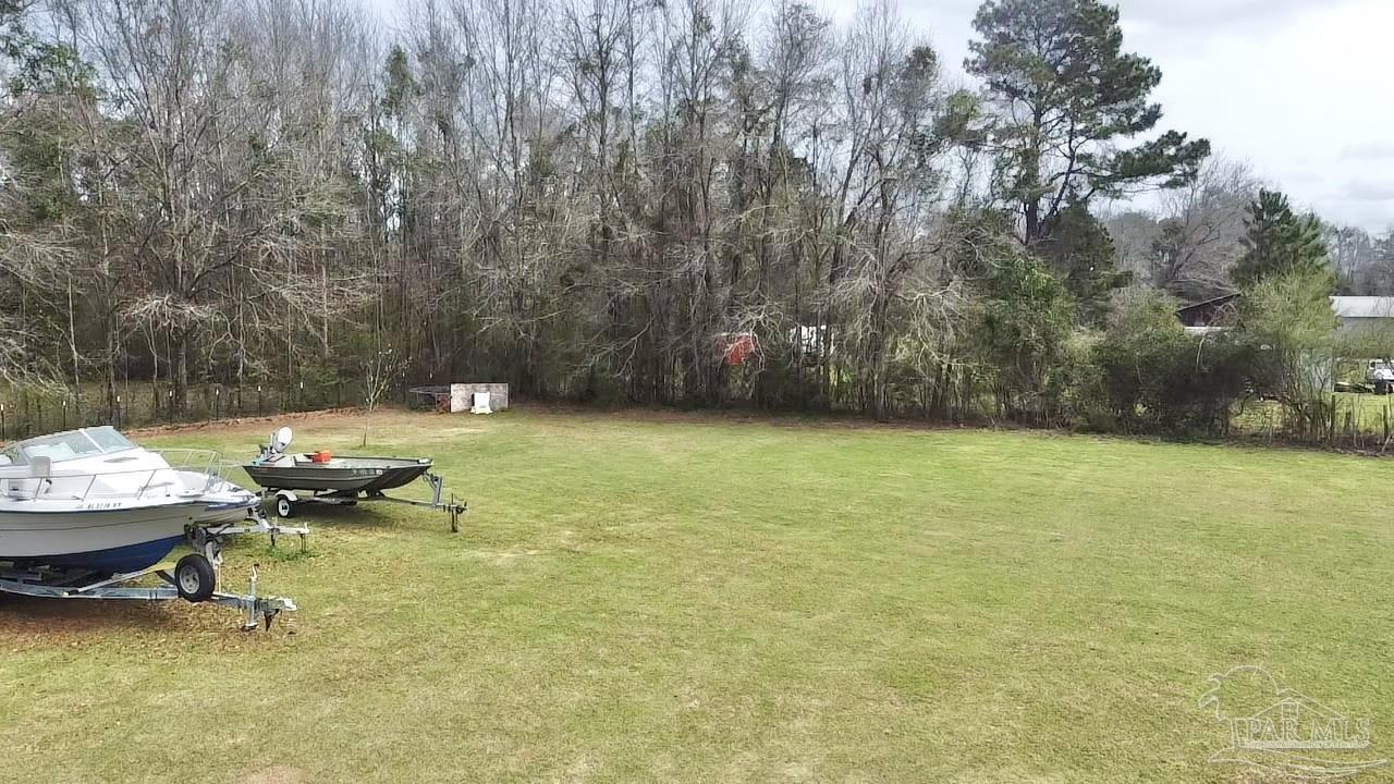887 Old Bratt Road Atmore, AL 36502 - Photo 36 of 41 a backyard of a house with table and chairs