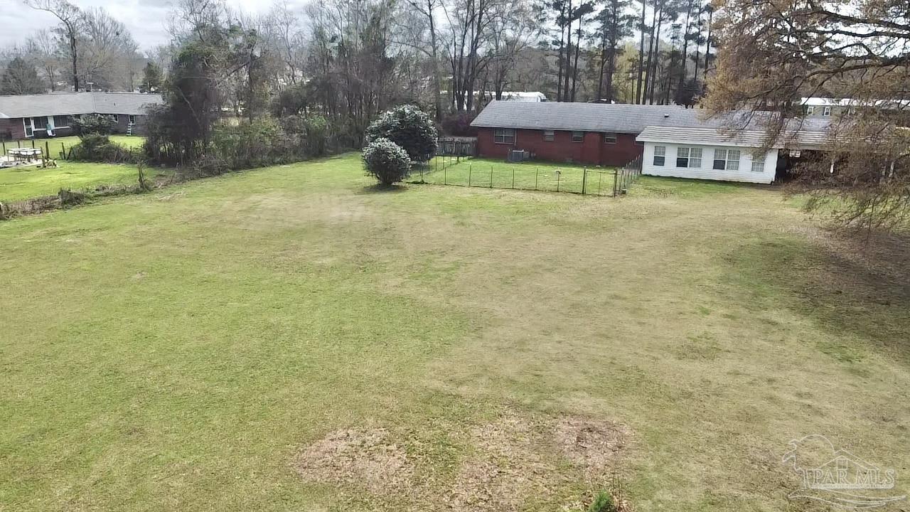 887 Old Bratt Road Atmore, AL 36502 - Photo 40 of 41 a backyard of a house with table and chairs