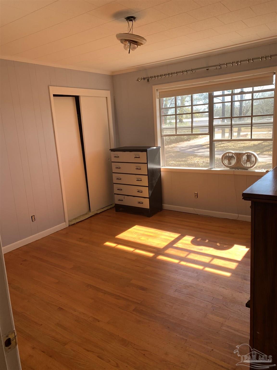 887 Old Bratt Road Atmore, AL 36502 - Photo 7 of 41 a view of empty room with wooden floor and fan