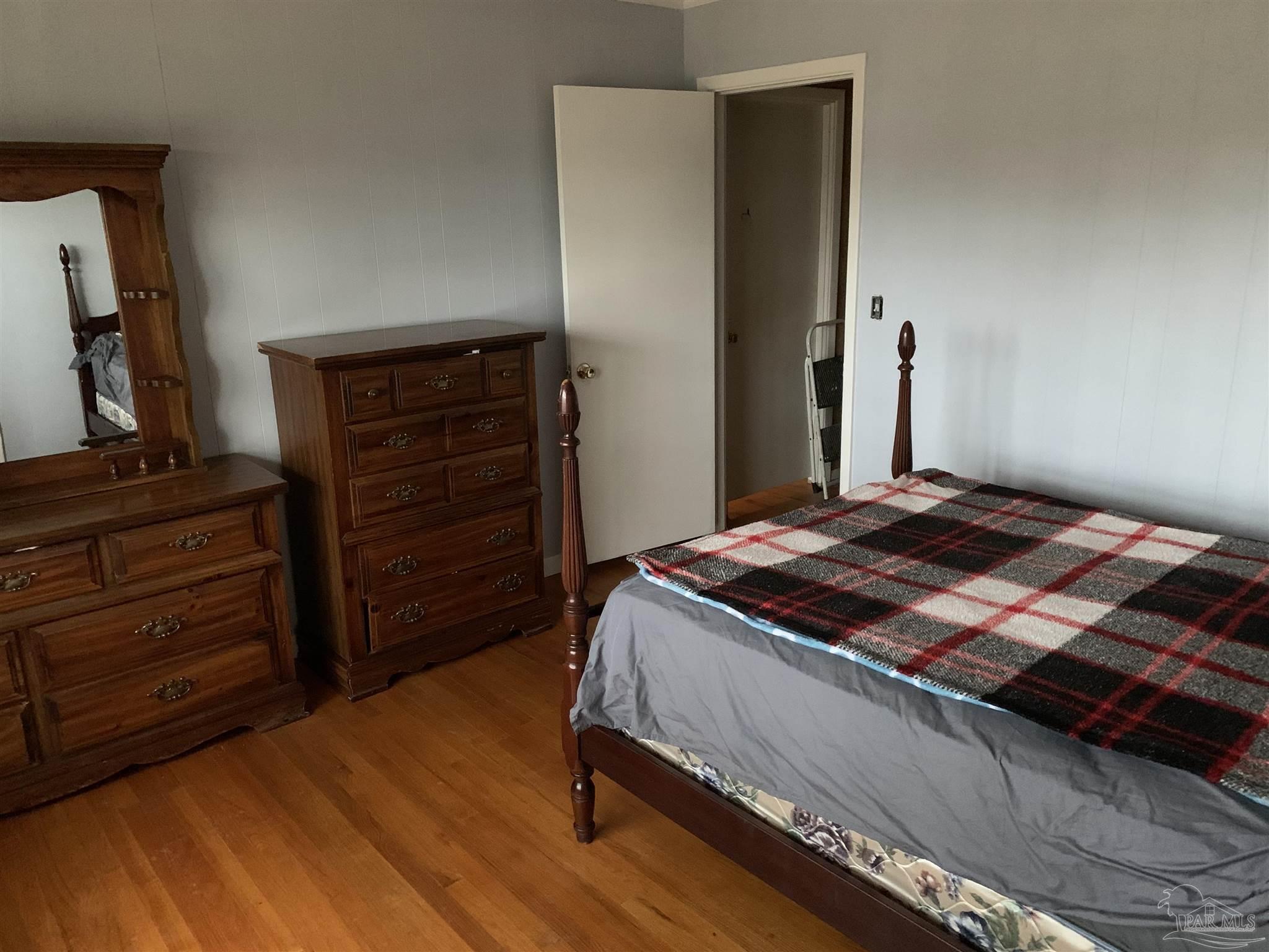 887 Old Bratt Road Atmore, AL 36502 - Photo 8 of 41 a bedroom with a bed and a dresser