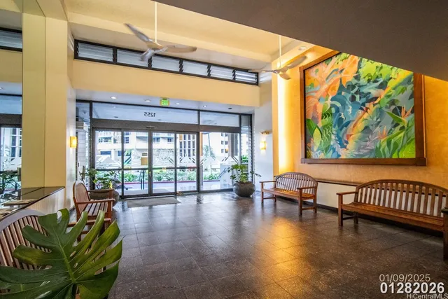 a lobby with furniture and floor to ceiling window