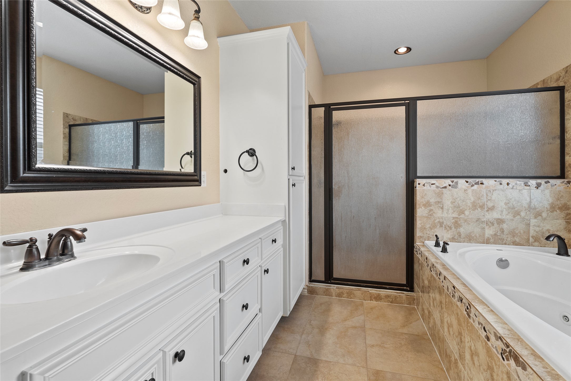 330 Arbors Circle Elgin, TX 78621 - Photo 18 of 37 Bathroom with a shower stall, tile patterned floors, vanity, and a jetted tub