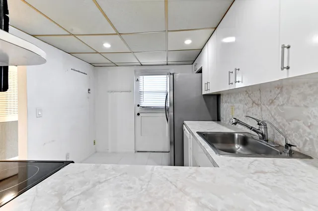 a kitchen with a stove a sink and refrigerator