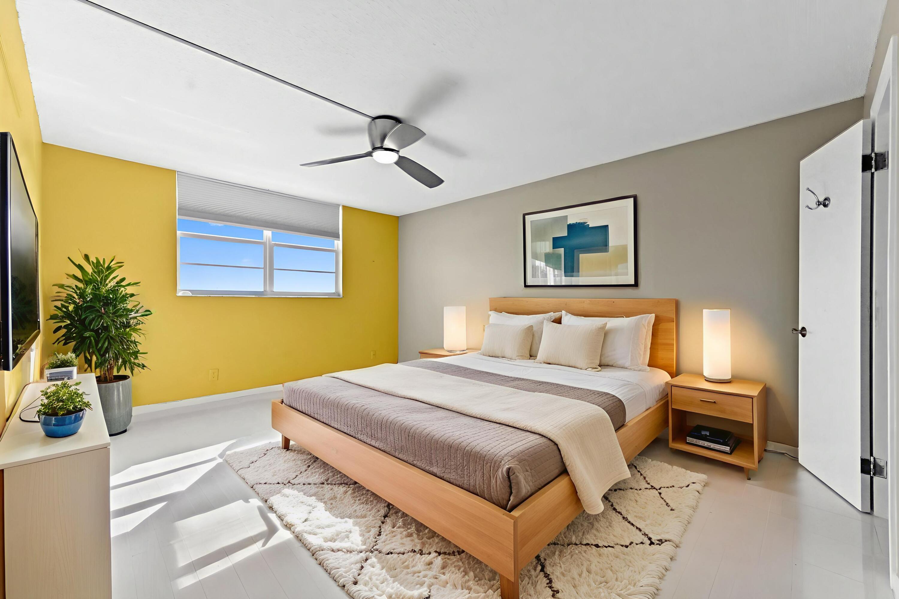 5700 Northwest 2nd Avenue, Unit 503 Boca Raton, FL 33487 - Photo 14 of 40 a bedroom with a large bed and a chandelier