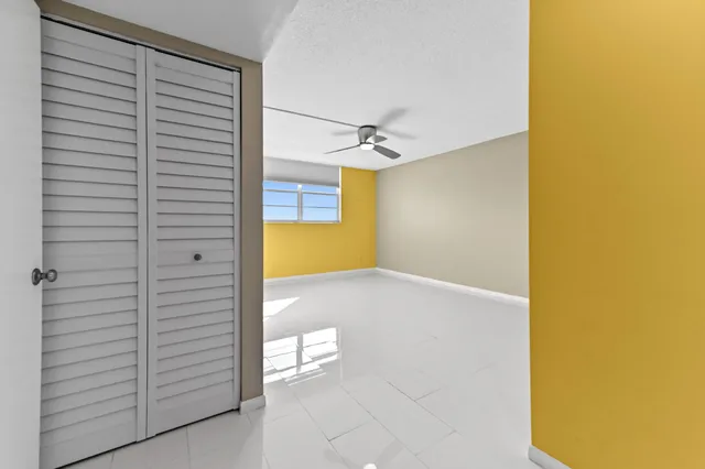a bathroom with a granite countertop toilet sink and mirror