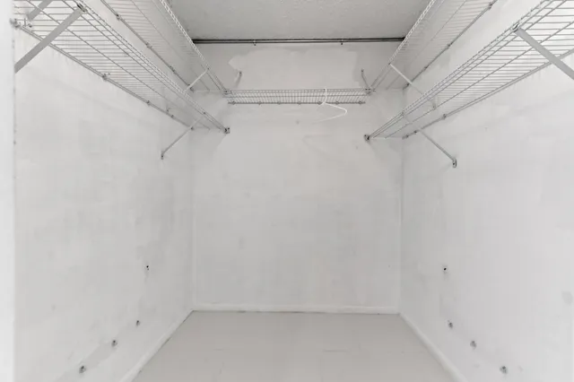 a bedroom with a bed and a potted plant