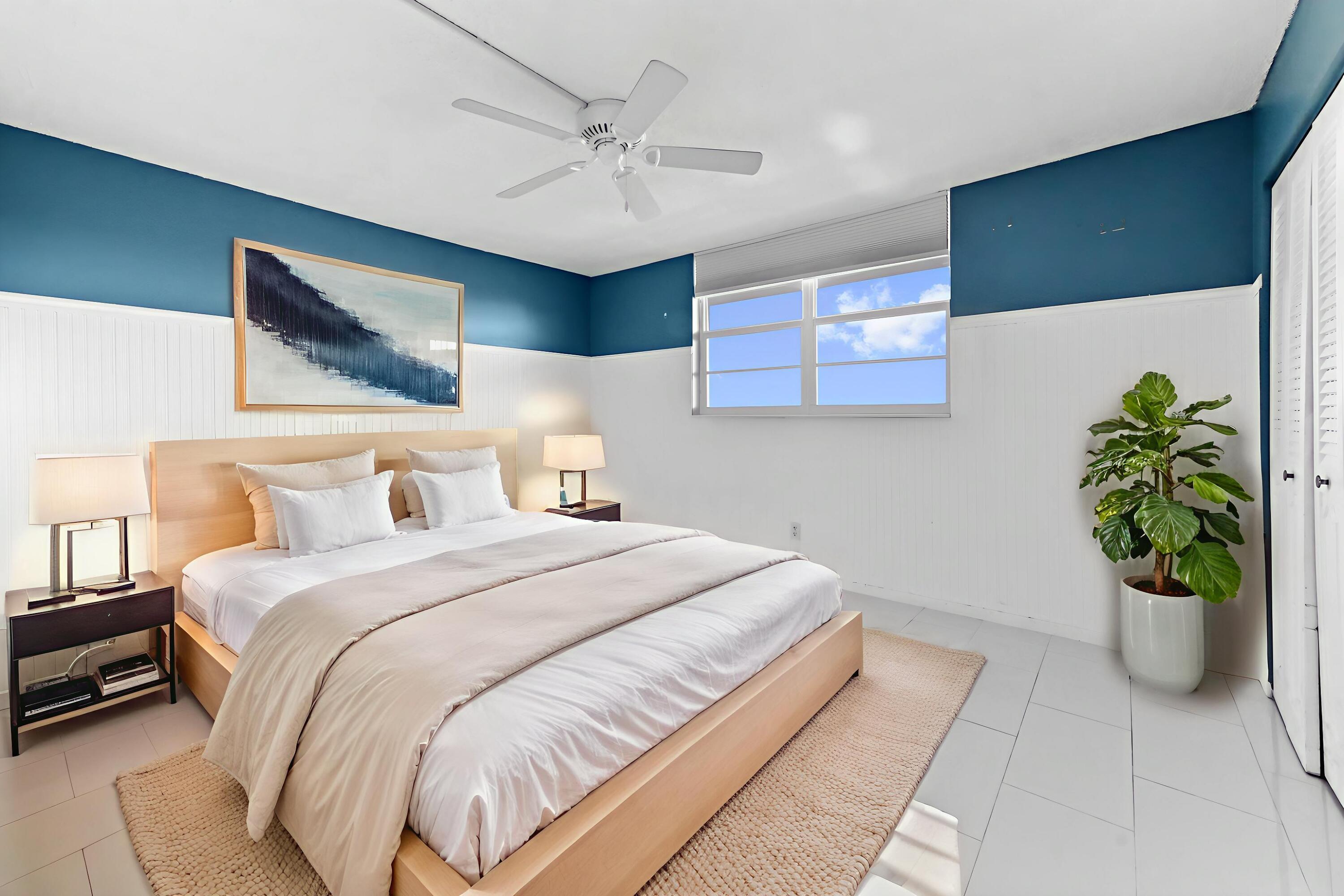 5700 Northwest 2nd Avenue, Unit 503 Boca Raton, FL 33487 - Photo 21 of 40 a bedroom with a bed and a potted plant