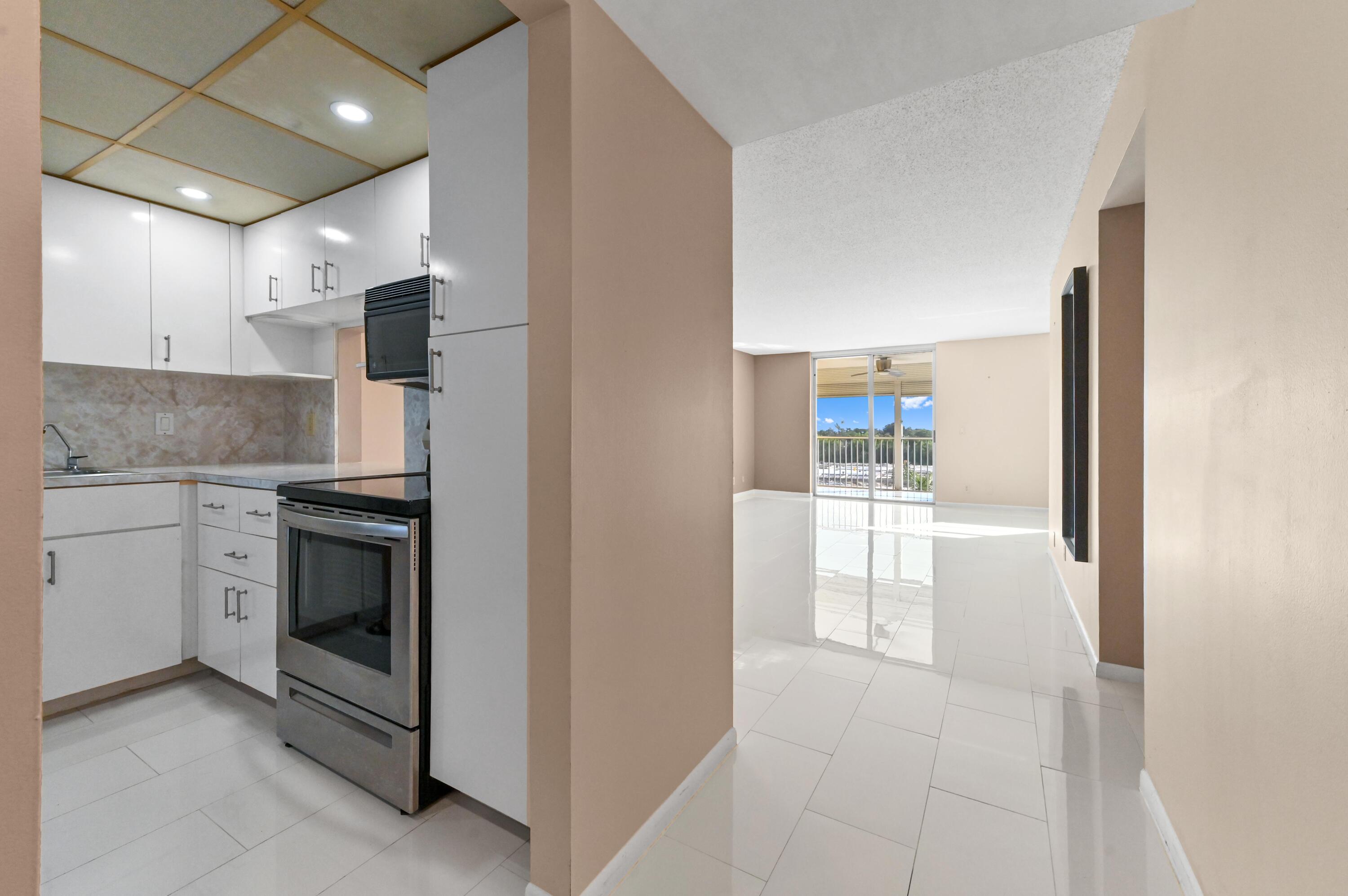 5700 Northwest 2nd Avenue, Unit 503 Boca Raton, FL 33487 - Photo 3 of 40 a kitchen with stainless steel appliances granite countertop a refrigerator a stove and a sink