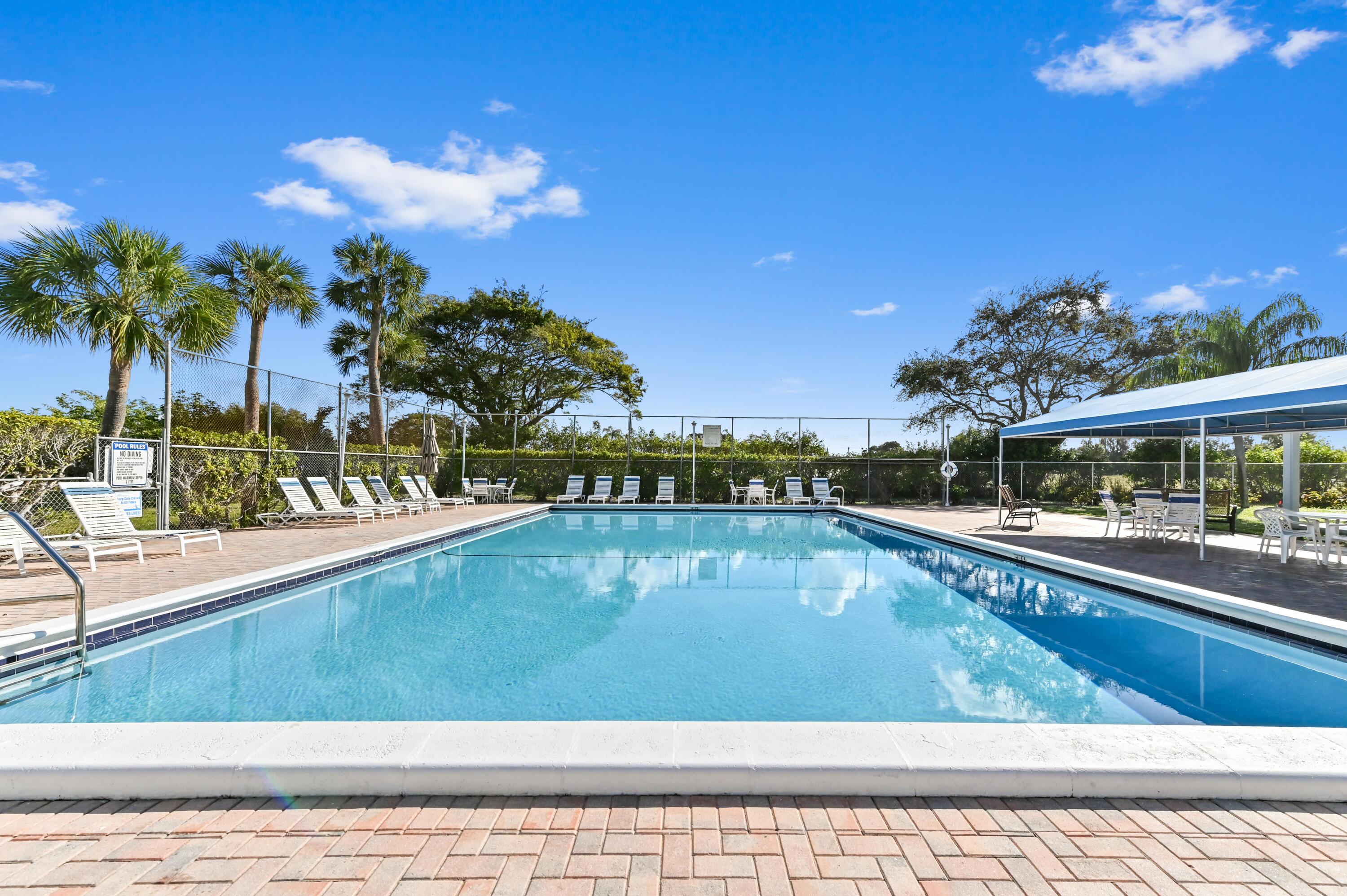 5700 Northwest 2nd Avenue, Unit 503 Boca Raton, FL 33487 - Photo 39 of 40 a view of a swimming pool with a lounge chair