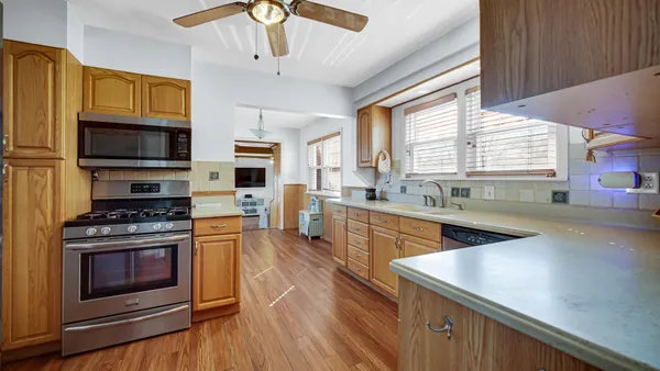 a kitchen with stainless steel appliances a stove a sink and a microwave
