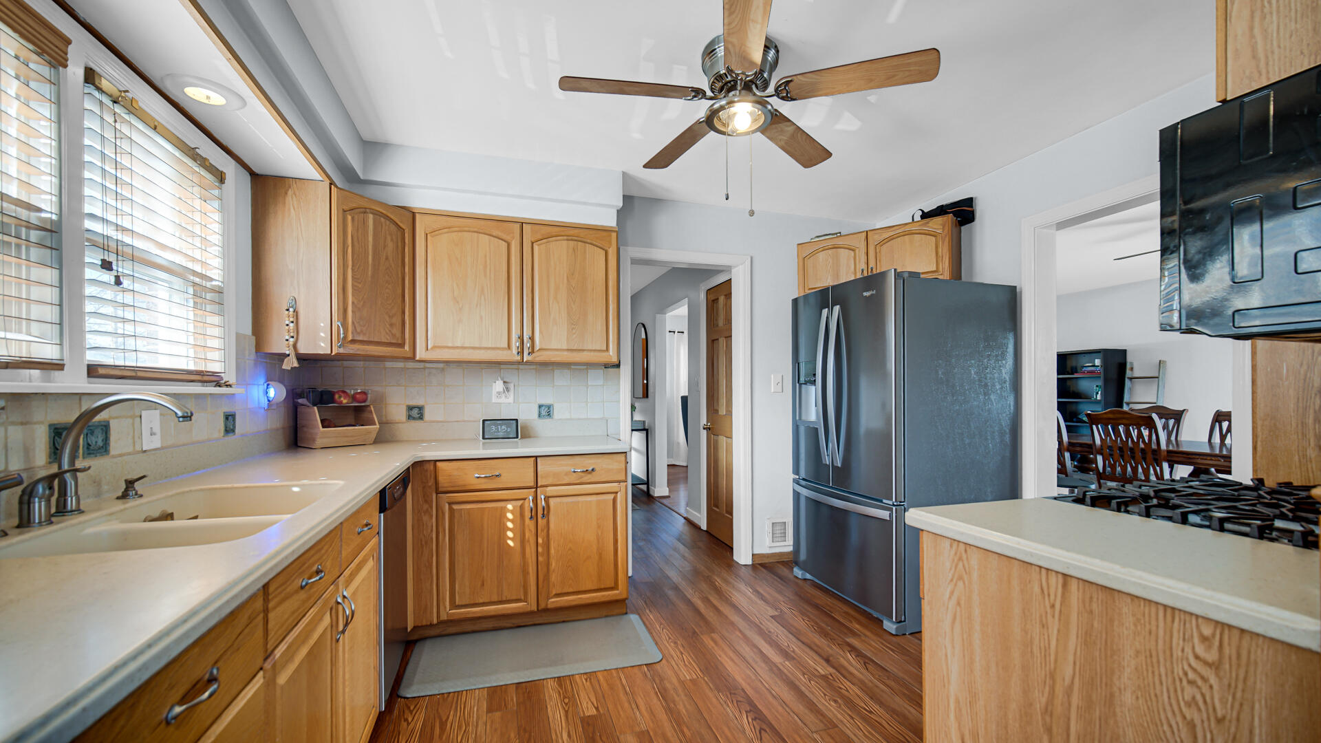 222 Beacon Place Munster, IN 46321 - Photo 12 of 30 a kitchen with stainless steel appliances a sink cabinets wooden floor and a window