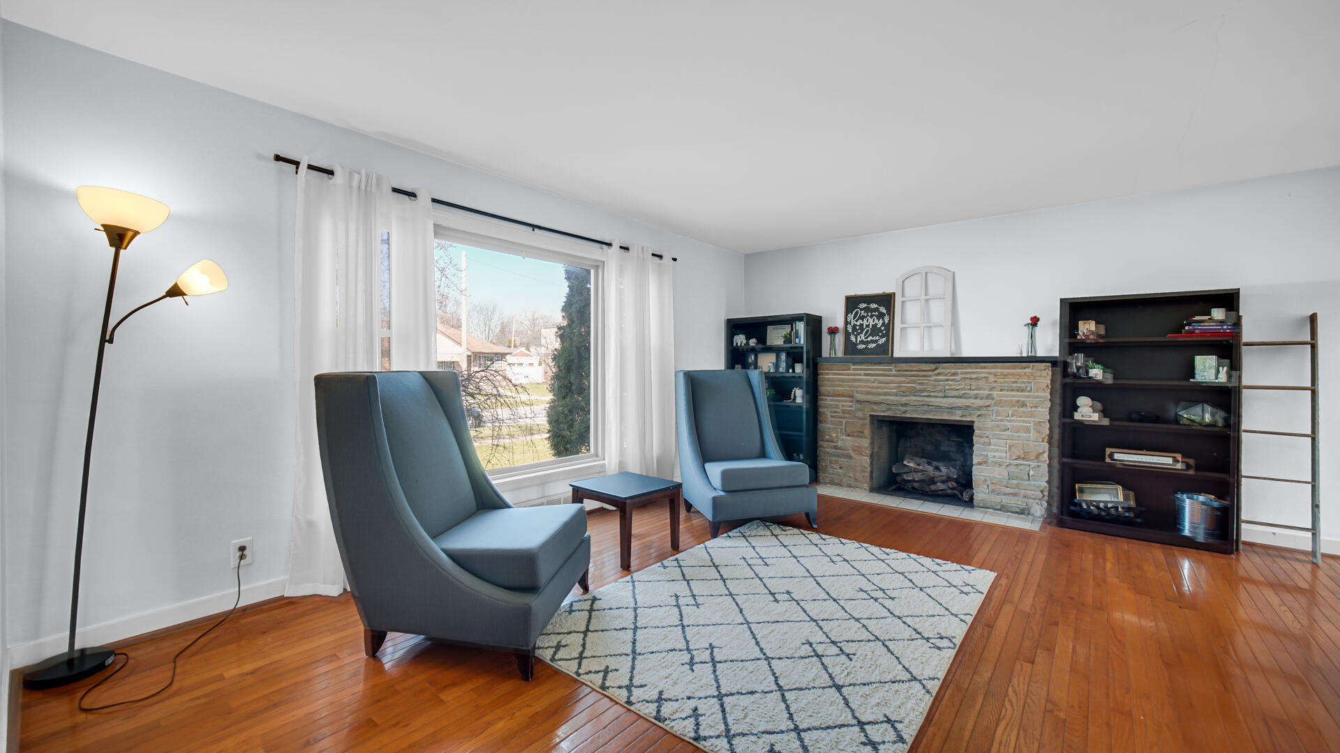 222 Beacon Place Munster, IN 46321 - Photo 6 of 30 a living room with furniture a fireplace and a flat screen tv