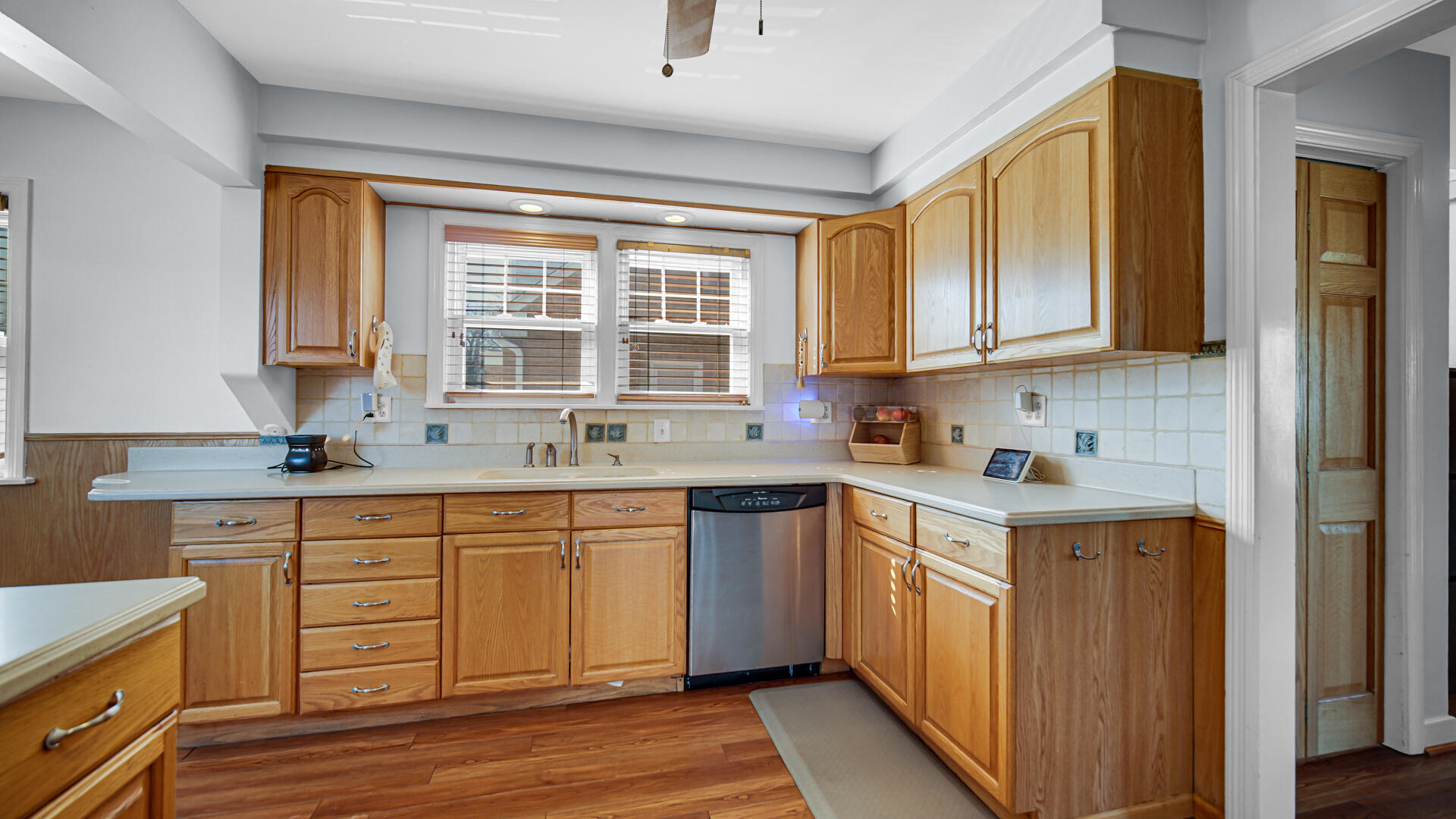 222 Beacon Place Munster, IN 46321 - Photo 10 of 30 a kitchen with stainless steel appliances granite countertop a sink and cabinets with wooden floors