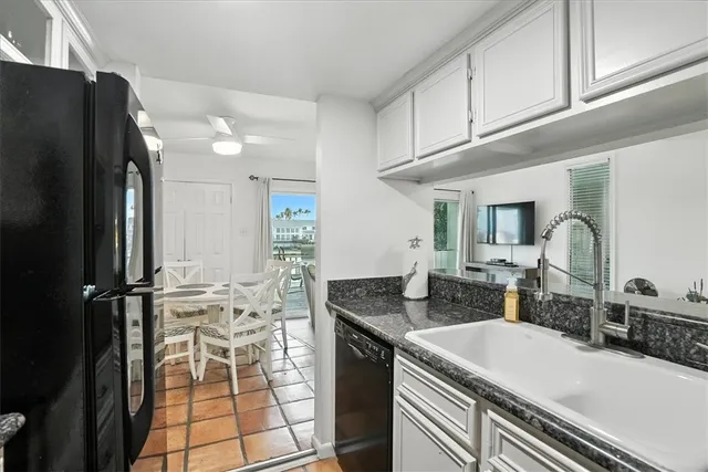 a kitchen with a sink appliances and cabinets