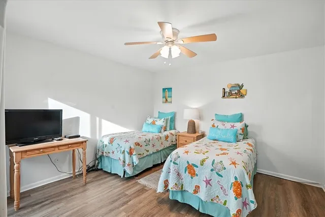 a bedroom with two beds and a flat screen tv