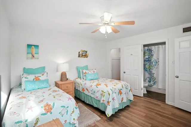 a bedroom with two beds and a chandelier