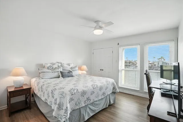 a bedroom with two beds and large window