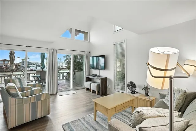 a living room with furniture and a floor to ceiling window